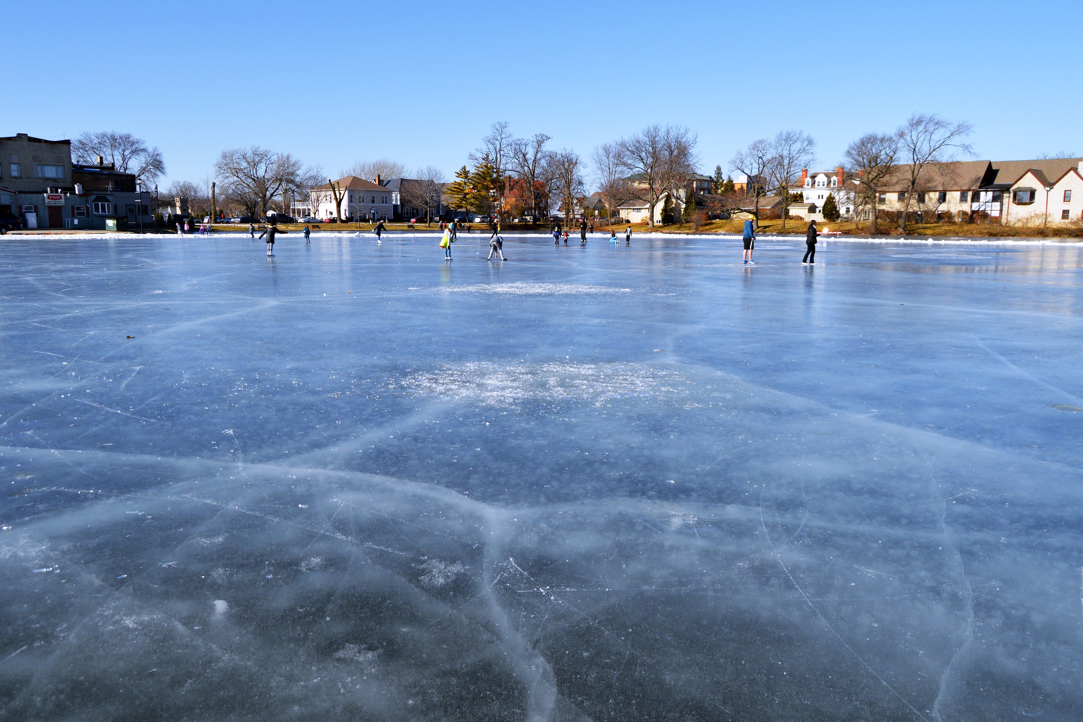 People playing on frozen lake