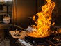 Frying pan on fire in kitchen