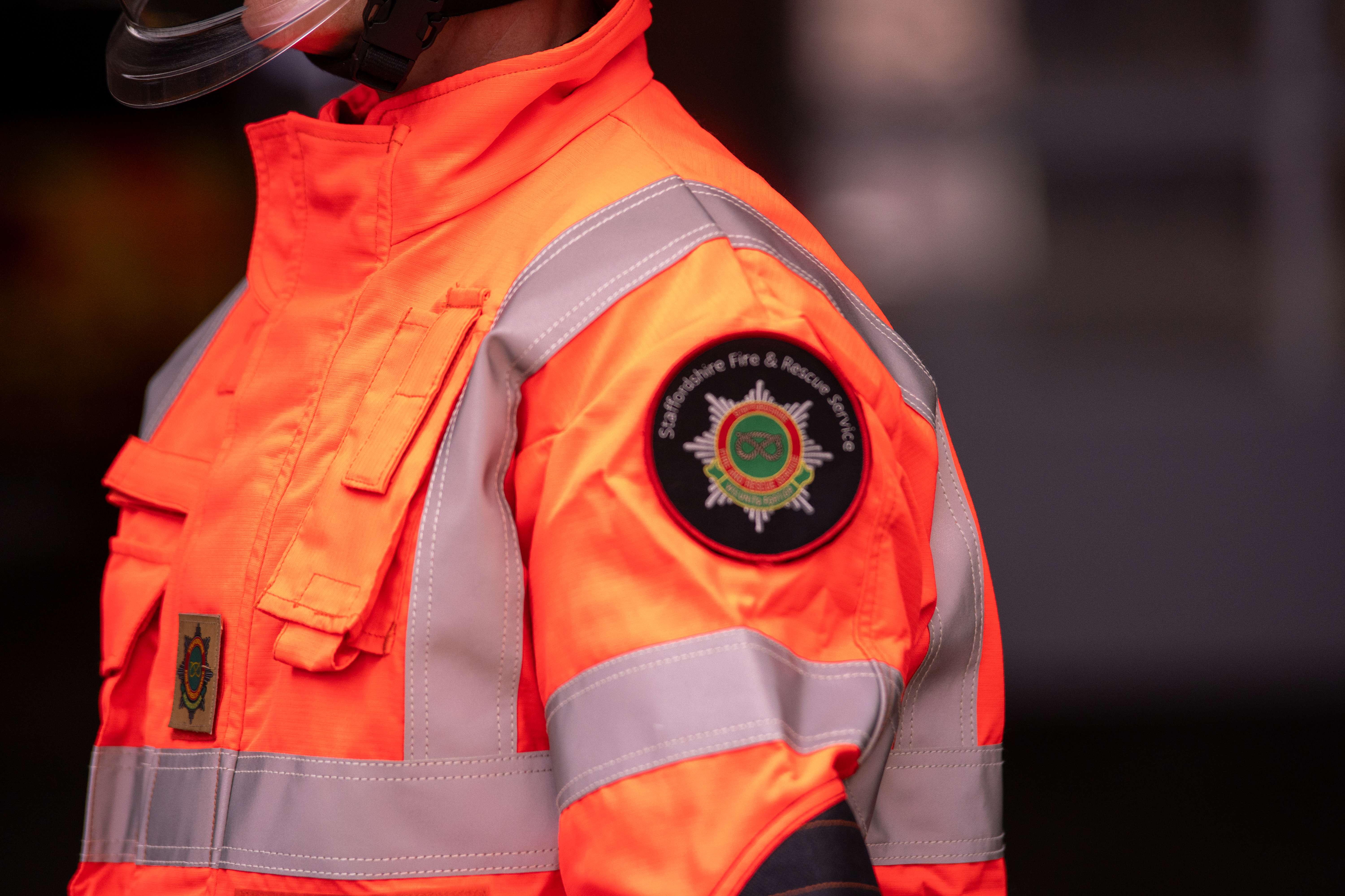 Close up of the Staffordshire Fire and Rescue service badge on the left shoulder of a firefighter jacket