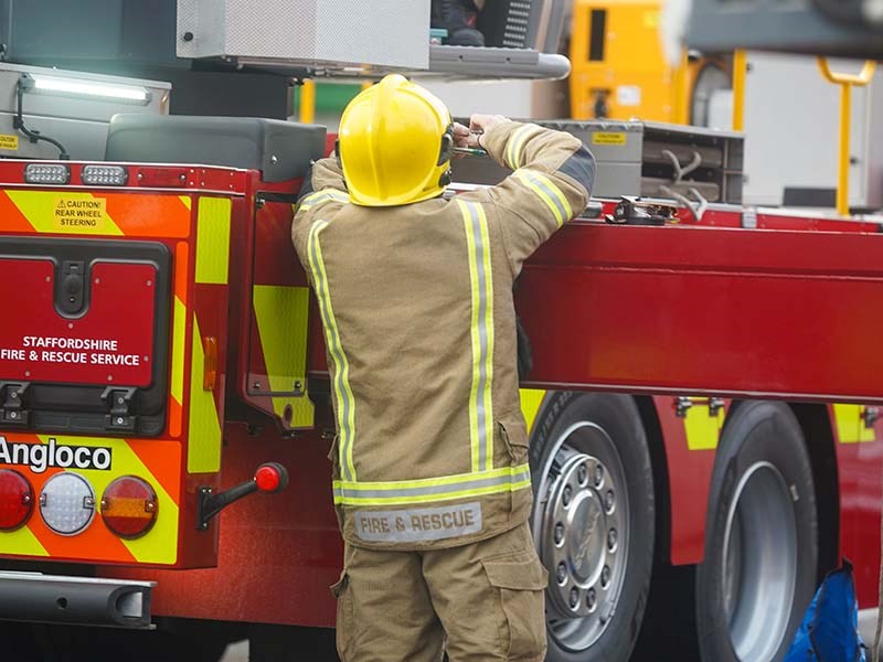 Firefighter operating ALP vehicle