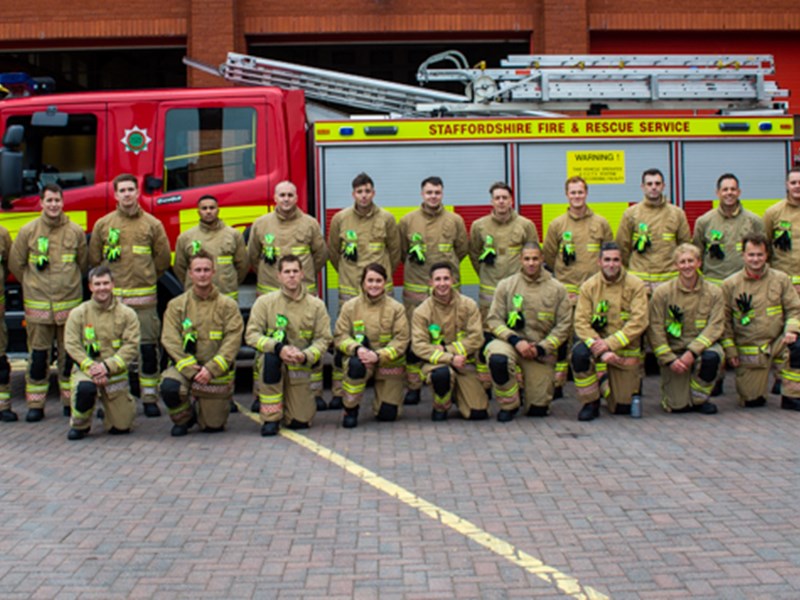Group of firefighters gathered in front of engine