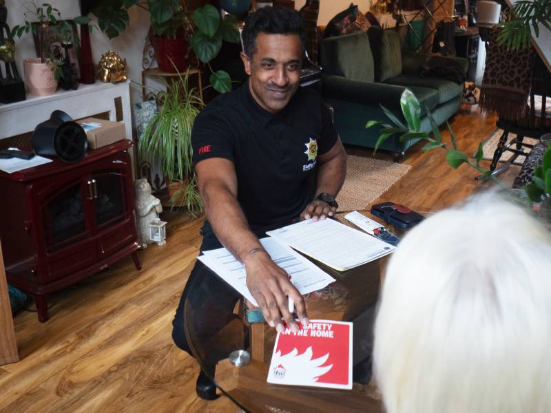 Firefighter visiting older person at home