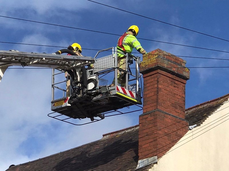 Firefighters looking in chimney from ALP