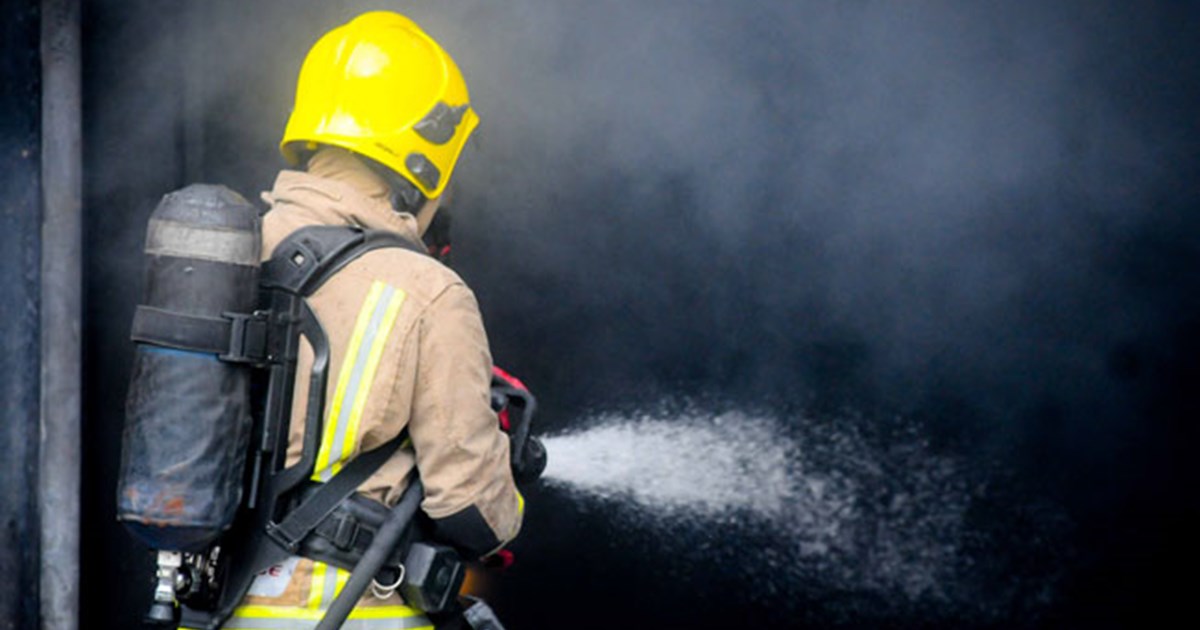 Firefighter extinguishing fire