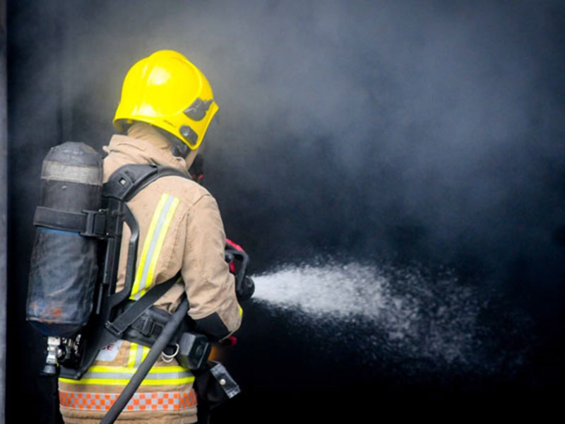 Firefighter extinguishing fire