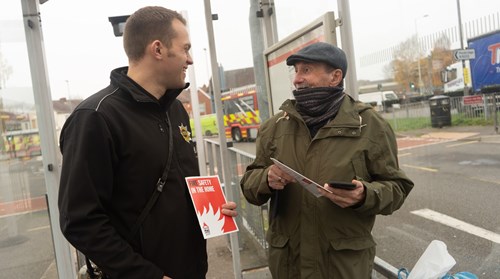 A local firefighter from Cannock chatting to a member of the public at Cannock Bus Station