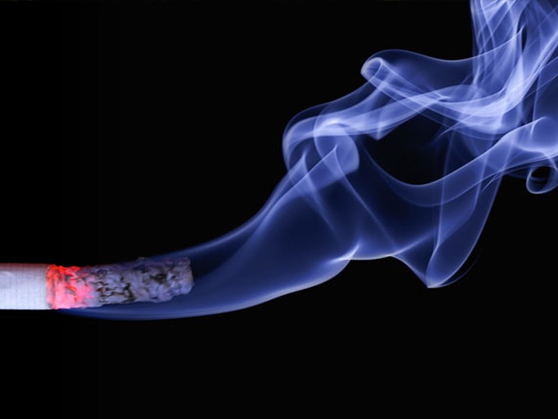 Burning cigarette with smoke