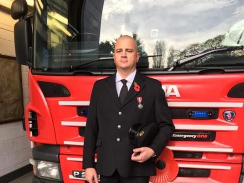 Firefighter, Alec Elwell, infront of truck