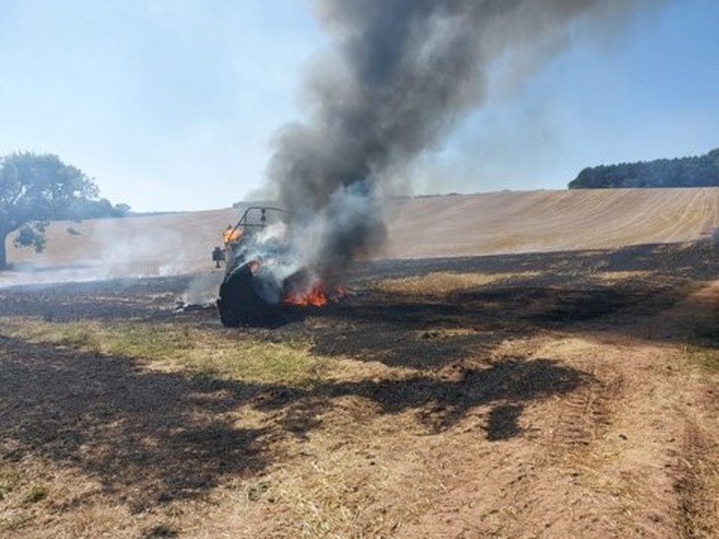 Combine harvester on fire